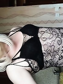 A blonde transgender woman is masturbating.